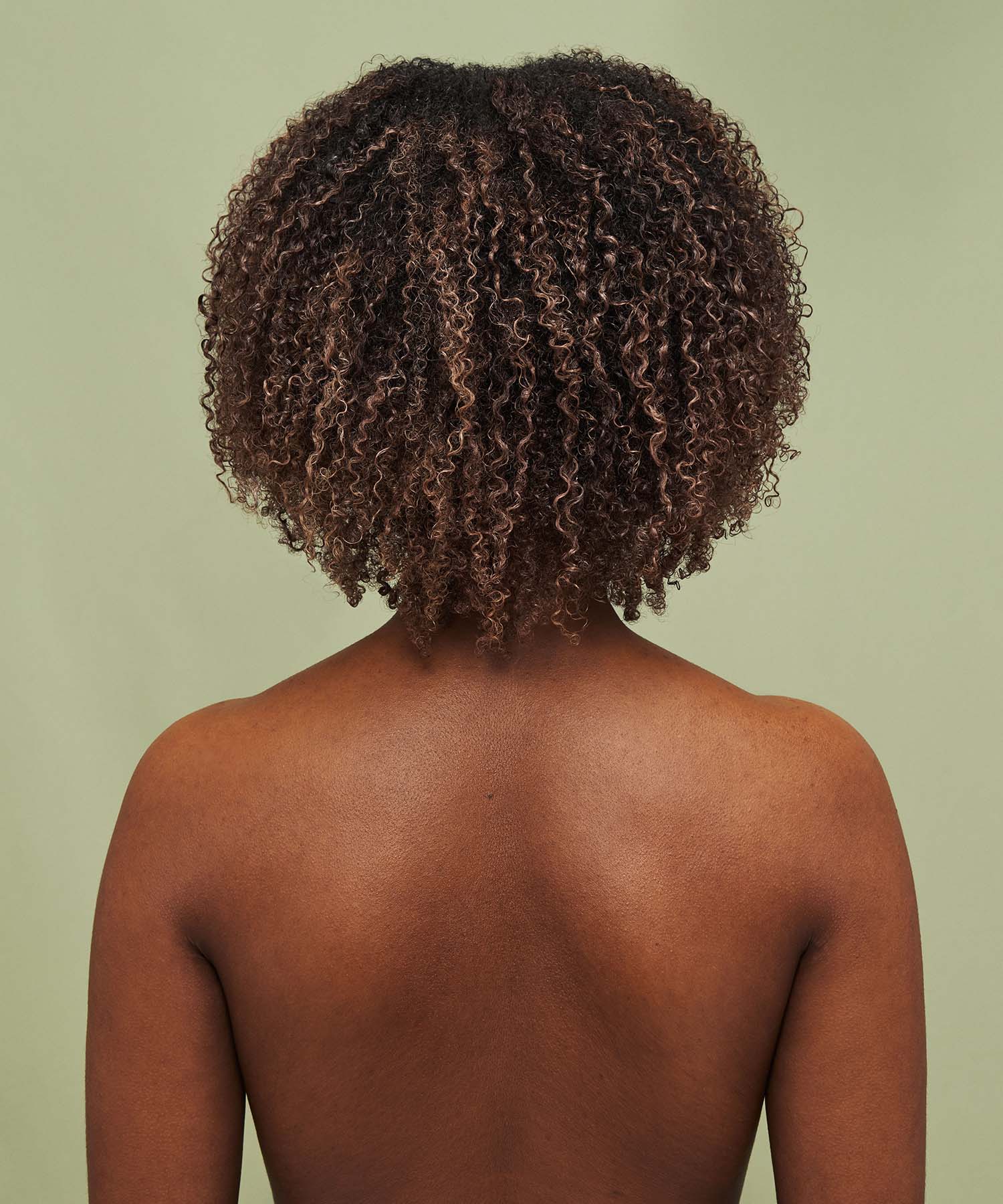 Result on hair after using Color Refresh Cool Cream against a green background