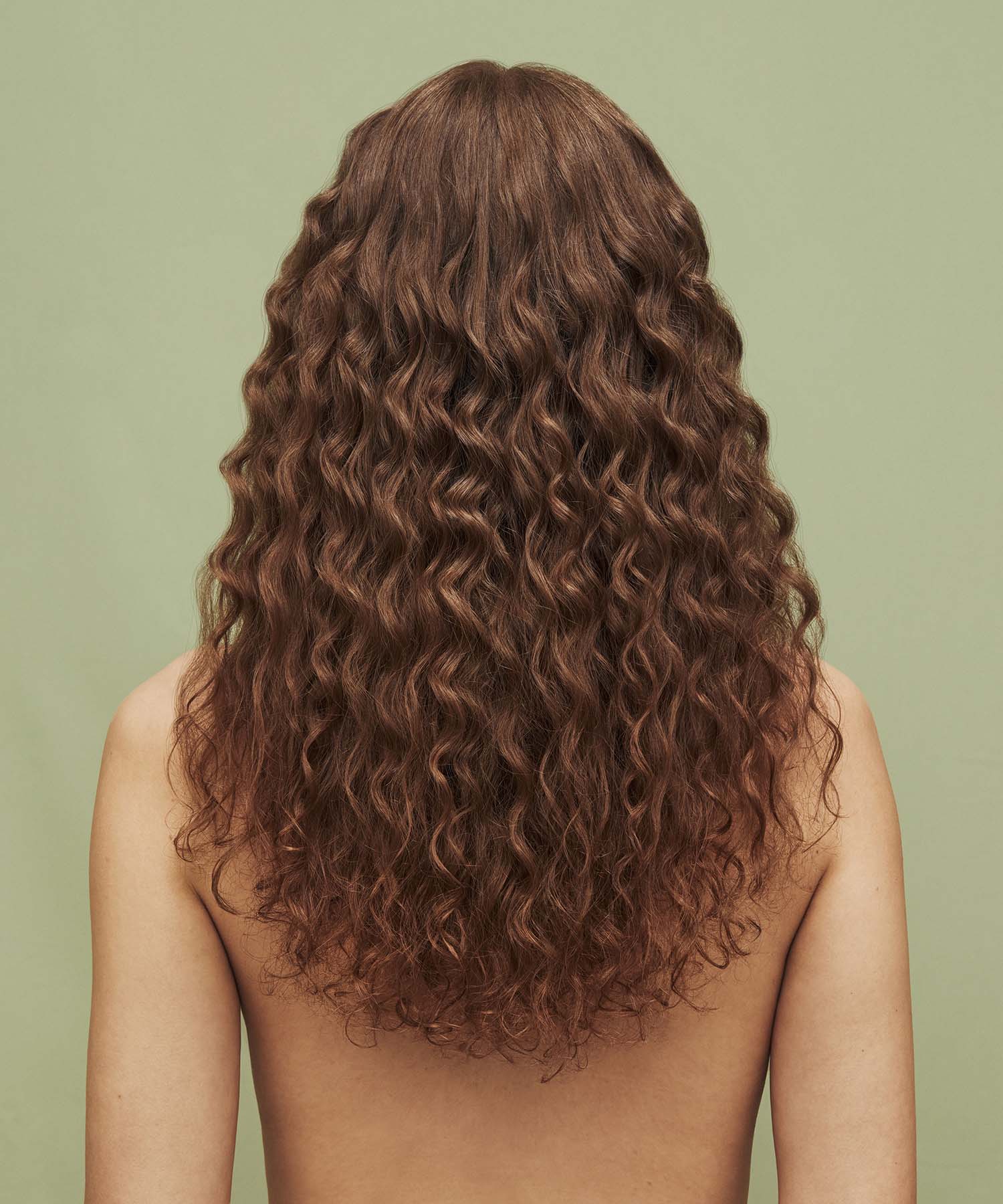 Result on hair after using Color Refresh Beige Brown against a green background